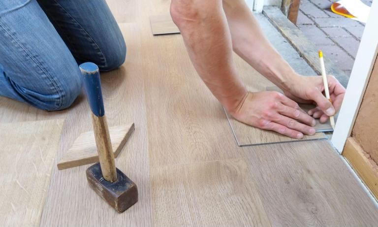 A person adding wood flooring to a home