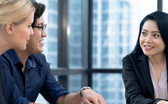 A couple discusses personal loans and credit with a credit union representative