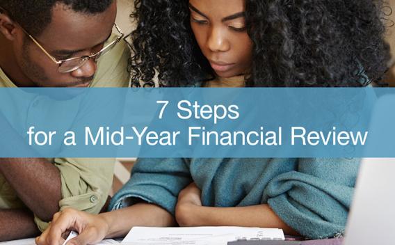 A man and woman looking at paperwork on a table with a laptop, and text displayed: 7 Steps for a Mid-Year Financial Review