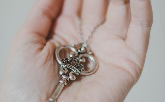 A fancy key resting in a person's open palm