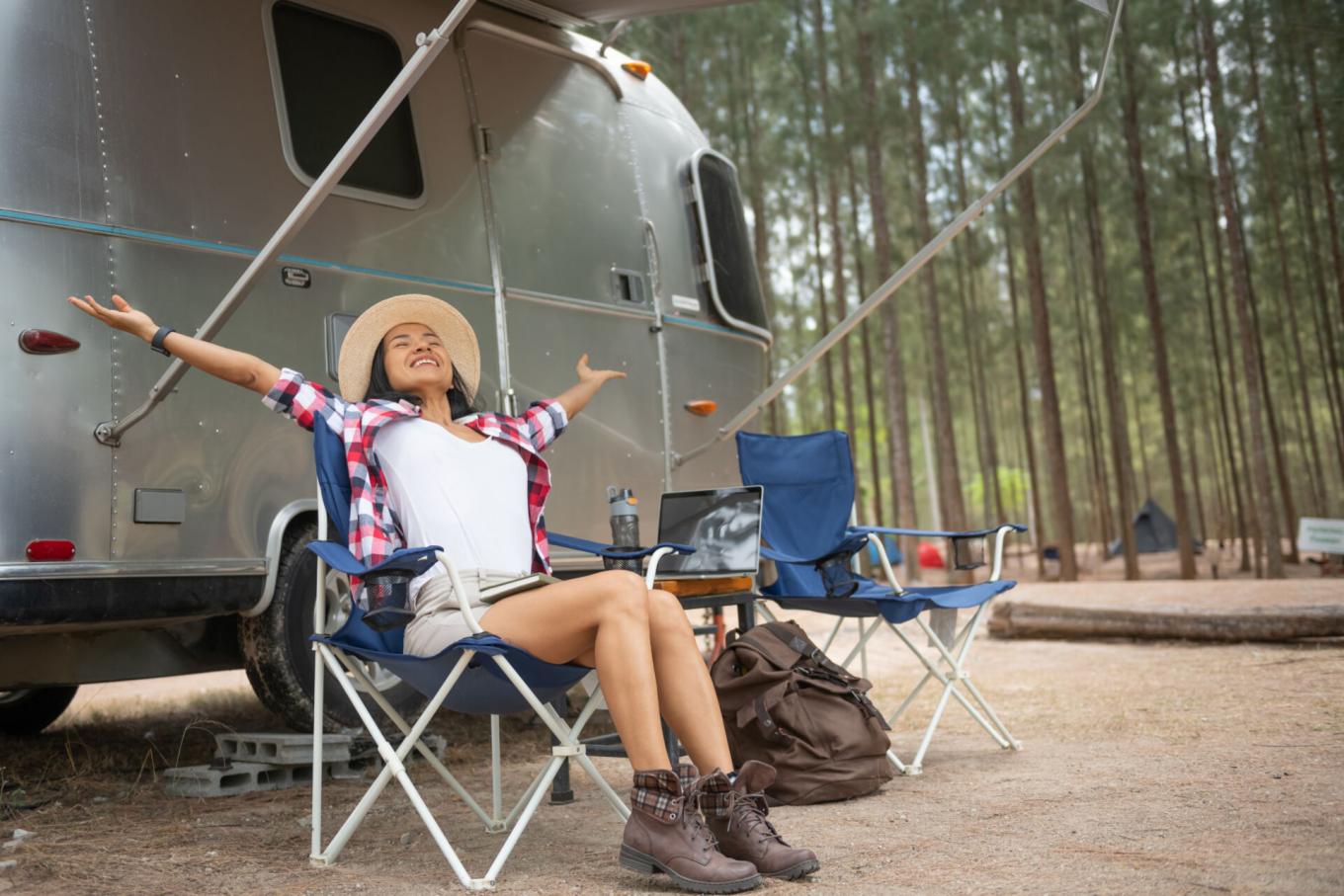 Person stretching their arms outside of an RV.